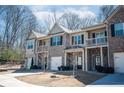 Desirable townhome with brick accents, quaint balconies, and attached garages on a tree-lined street at 2544 Castellan Dr, Atlanta, GA 30316