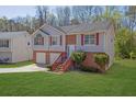 Exterior of home with lush green lawn, trees, driveway, and brick accents at 3021 Hampton Club Way, Lithonia, GA 30038