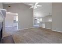 Open-concept living room with fireplace, vaulted ceilings, neutral paint, and carpet at 3021 Hampton Club Way, Lithonia, GA 30038