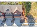 An aerial view shows this brick home, nestled among mature trees, featuring a spacious two-car garage at 362 Braemore Mill Dr, Lawrenceville, GA 30044