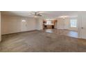 Open-concept living room featuring carpet, and tile that leads to the kitchen with stainless steel appliances at 537 Pine Shadows Dr, Dallas, GA 30157