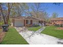 Brick home with a garage and long driveway and lush green lawn at 2261 Headland Ter, Atlanta, GA 30344