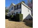 Two-story home with gray siding, black shutters, and manicured landscaping at 2295 Golden Valley Dr, Lawrenceville, GA 30043