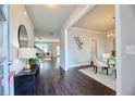 Inviting entryway with dark wood floors, console table, and views into the dining and living areas at 3557 Bryant Meadow Cir, Buford, GA 30519
