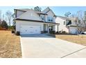 Beautiful home with a spacious driveway leading to an attached two-car garage at 3557 Bryant Meadow Cir, Buford, GA 30519
