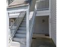 Exterior stairway with light grey metal handrails and light grey painted surfaces, leading to upper units at 6379 Wedgeview Ct # 6379, Tucker, GA 30084
