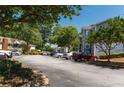 Wide view of an asphalt parking lot surrounded by trees and the residential apartment buildings at 6379 Wedgeview Ct # 6379, Tucker, GA 30084