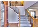Elegant foyer featuring hardwood floors, staircase with iron spindles, and soaring ceilings at 6921 Springbank Way, Stone Mountain, GA 30087