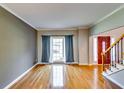Inviting living room featuring hardwood floors, a large window, and access to the front entrance at 6921 Springbank Way, Stone Mountain, GA 30087