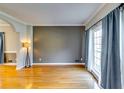 Bright living room with hardwood floors, large window with curtains, and neutral color scheme at 6921 Springbank Way, Stone Mountain, GA 30087