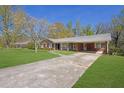 Traditional home showcasing a brick exterior, a spacious driveway and attached carport at 2609 Colonial Dr, Atlanta, GA 30337