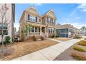 Beautiful two-story home with neutral siding, stone accents, and a welcoming front porch at 3534 Diplomat Aly, Scottdale, GA 30079