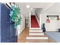 Inviting foyer with hardwood floors, stairway, and decorative wreath on the front door at 4076 Shady Nw Cir, Lilburn, GA 30047