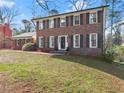 Charming brick home featuring a manicured lawn, dark shutters, and a welcoming front entrance at 4076 Shady Nw Cir, Lilburn, GA 30047