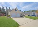 Inviting one-story home with a two-car garage and manicured lawn at 5016 Larkspur Ln, Atlanta, GA 30349