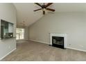 Cozy living room with a fireplace and an open view to the kitchen at 5016 Larkspur Ln, Atlanta, GA 30349