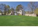Beautiful home features a well-maintained lawn, a fenced yard, and a cozy backyard at 1124 Brandon Hill Way, Jonesboro, GA 30238