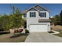 Charming two-story home with a well-maintained lawn and a two-car garage at 3836 Saddle Hill Way, Douglasville, GA 30135
