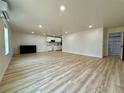 Spacious living room with light wood floors and an adjacent modern kitchen offers a functional layout at 3836 Saddle Hill Way, Douglasville, GA 30135