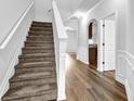 Bright entryway with hardwood floors and a carpeted staircase at 5456 Union Hill Ct, Union City, GA 30291