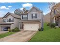 Two-story home with vinyl siding, brick accents, two-car garage, and a well-maintained lawn at 5456 Union Hill Ct, Union City, GA 30291