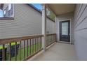 Inviting front porch with wood railing leading to a black front door at 5456 Union Hill Ct, Union City, GA 30291