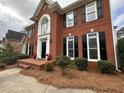 Charming brick home featuring black shutters and landscaped front yard at 772 Vinings Estates Se Dr, Mableton, GA 30126