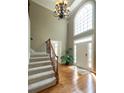 Bright foyer features hardwood floors, high ceilings, a chandelier, and large windows offering natural light at 772 Vinings Estates Se Dr, Mableton, GA 30126