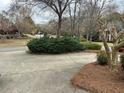 View of the home's front yard, showcasing well-maintained landscaping and mature trees at 772 Vinings Estates Se Dr, Mableton, GA 30126