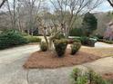 Landscaped front yard with mature trees adds to the curb appeal of this home at 772 Vinings Estates Se Dr, Mableton, GA 30126