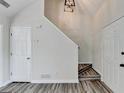 Bright foyer area featuring hardwood flooring, stairs to the left, and a convenient coat closet at 1335 Jamestowne Trl, Alpharetta, GA 30009