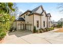 Spacious three-car garage with a paved driveway, complemented by the home's brick exterior and landscaping at 5915 Brookgreen Rd, Atlanta, GA 30328