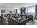 Elegant living room with plush seating, hardwood floors, large windows with city views, and stylish decor at 75 14Th Ne St # 4150, Atlanta, GA 30309