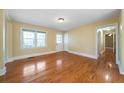 Inviting living room with gleaming hardwood floors, neutral paint, and a large window at 1025 Pace Rd, Hiram, GA 30141