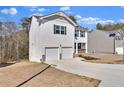 Two-story home with a two-car garage, black shutters, and low-maintenance landscaping at 1054 Mackets Ct, Atlanta, GA 30354