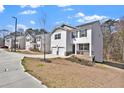 Neighborhood view of a two-story home with a two-car garage and a cozy front porch at 1054 Mackets Ct, Atlanta, GA 30354