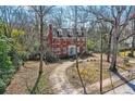 Charming brick home features a well-maintained lawn and mature trees at 1305 Fairview Ne Rd, Atlanta, GA 30306