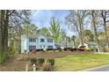 Inviting two-story home with blue shutters, attractive landscaping, and a neatly terraced front yard at 4083 Rivermeade Sw Dr, Lilburn, GA 30047