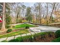 Driveway leading to a home surrounded by mature trees and lush greenery, offering privacy and a serene setting at 3790 Narmore Ne Dr, Atlanta, GA 30319