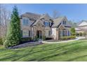 Beautiful two-story home featuring a lush green lawn and meticulous landscaping at 4296 Alba Ln, Buford, GA 30519