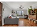 Bright living room features hardwood floors, a ceiling fan, a large window, and gray sofa at 708 Argonne Ne Ave # 5, Atlanta, GA 30308