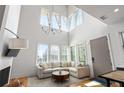 Bright living room featuring a cozy seating area, large windows, and soaring ceilings at 155 Breakspear Ln, Fayetteville, GA 30214