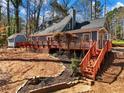 Charming home featuring a large wooden deck and beautifully landscaped backyard at 2466 Thrasher Rd, Buford, GA 30519