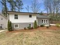 Charming home with a gray brick and white exterior and well-maintained landscaping, creating curb appeal at 4095 Kenora Sw Dr, Atlanta, GA 30331