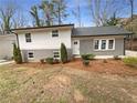 Charming home with a gray brick and white exterior and well-maintained landscaping, creating curb appeal at 4095 Kenora Sw Dr, Atlanta, GA 30331