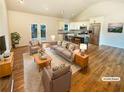 Bright living room featuring hardwood floors, neutral furniture, and access to outdoor deck at 4095 Kenora Sw Dr, Atlanta, GA 30331