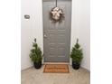 Welcoming gray front door is nicely decorated with a wreath and potted topiaries at 821 Ralph Mcgill Ne Blvd # 3209, Atlanta, GA 30306