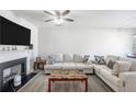 Comfortable living room with modern fireplace and neutral color scheme at 156 Haven Oak Way, Lawrenceville, GA 30044