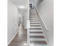 Bright staircase with hardwood steps and white banister at 156 Haven Oak Way, Lawrenceville, GA 30044