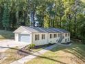 Attractive single-story home with a garage, brick details, and a well-kept lawn, perfect for suburban living at 2418 Bolling Brook Sw Dr, Atlanta, GA 30311